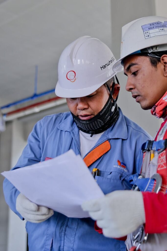 Two Man Holding White Paper