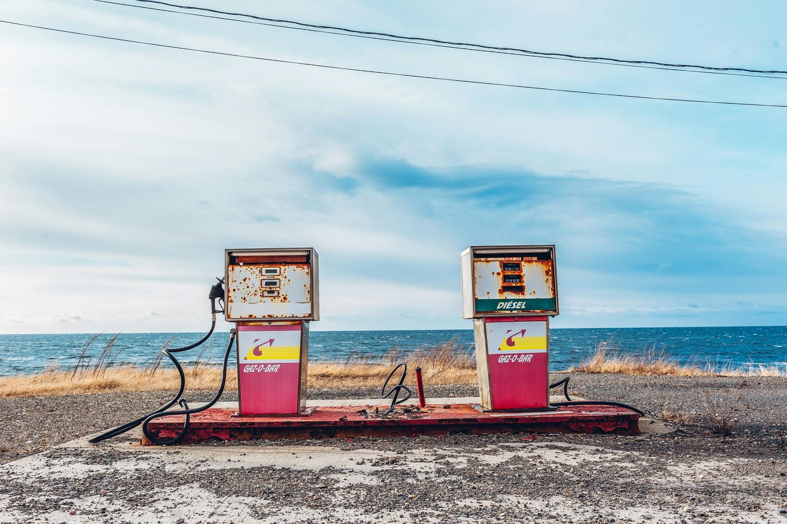 White and Pink Gasoline Station Near Ocean